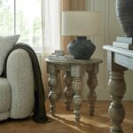 Rutland Collection round wooden side table in warm brown finish.