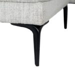 White three-seater sofa with textured fabric upholstery, matching footstool, and slim black metal legs.