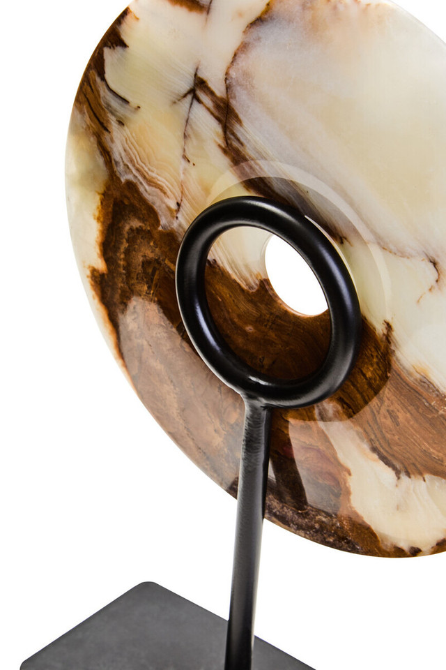 Polished round onyx disc in natural earthy tones displayed on a black metal stand.