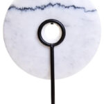 The ZORO Medium White Marble Disc Sculpture features a polished white marble disc with natural veining mounted on a sleek black metal stand, offering a refined and minimalist decorative accent.