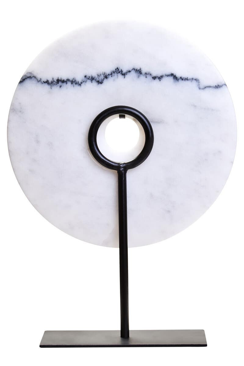 The ZORO Medium White Marble Disc Sculpture features a polished white marble disc with natural veining mounted on a sleek black metal stand, offering a refined and minimalist decorative accent.