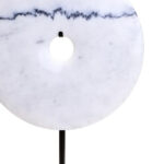 The ZORO Medium White Marble Disc Sculpture features a polished white marble disc with natural veining mounted on a sleek black metal stand, offering a refined and minimalist decorative accent.