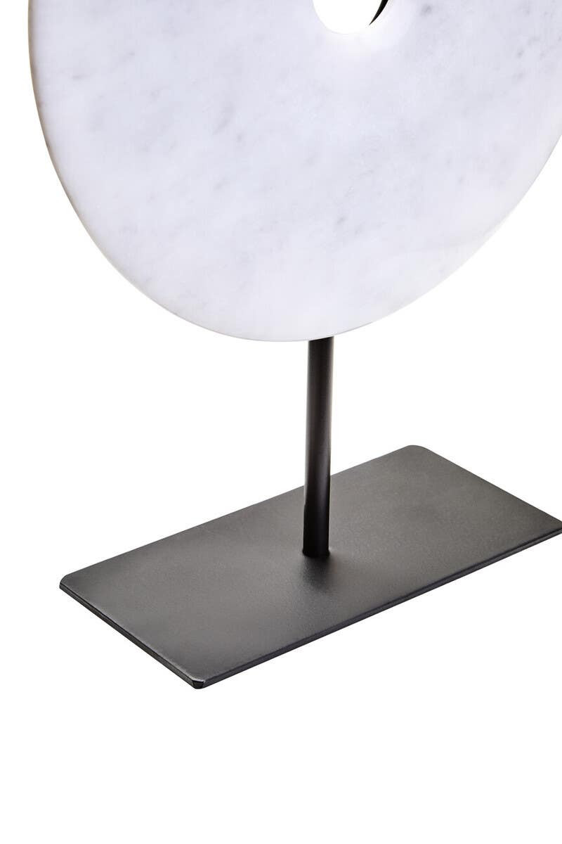 The ZORO Medium White Marble Disc Sculpture features a polished white marble disc with natural veining mounted on a sleek black metal stand, offering a refined and minimalist decorative accent.