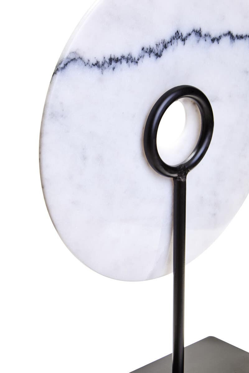 The ZORO Medium White Marble Disc Sculpture features a polished white marble disc with natural veining mounted on a sleek black metal stand, offering a refined and minimalist decorative accent.