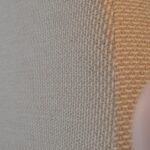 WAVE bed in natural weave fabric with curved upholstered headboard and round wooden legs in neutral modern bedroom.