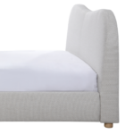 WAVE bed in natural weave fabric with curved upholstered headboard and round wooden legs in neutral modern bedroom.