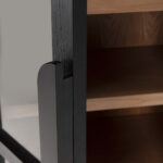 James ashwood display cabinet with black frame, walnut interior and glass doors in tall arched design.