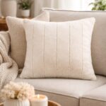 Empress cream faux fur feather filled cushion with soft velvet texture for cosy interior styling.
