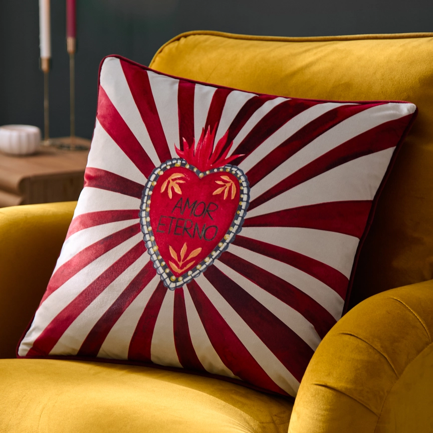 Amor velvet piped cushion in red with bold Mexican inspired pattern and feather filling.