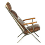 Brown genuine leather quilted chair with iron frame and curved wooden armrests, designed for industrial-style modern interior seating.