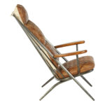 Light brown quilted leather chair with iron frame and wooden armrests, designed for industrial-style modern interior seating.