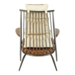 Light brown quilted leather chair with iron frame and wooden armrests, designed for industrial-style modern interior seating.