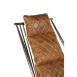 Light brown quilted leather chair with iron frame and wooden armrests, designed for industrial-style modern interior seating.