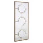 Tall rectangular wall mirror with antique silver circular accents, intersecting light wood frame, and geometric mid-century modern design for elegant interiors.