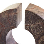 Abstract forest green marble sculpture with circular cut-out and cylindrical base, designed as a luxury decorative accent for modern interiors.