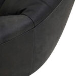 ntique black leather cocoon lounge chair with pleated upholstery and curved high-back design for modern luxury interior seating.