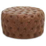 Round tufted leather ottoman in vintage brown with button detailing and cushioned top, designed for classic and rustic interior seating.