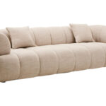 Cream linen curved three seater sofa with channel tufted detailing and rounded back design for modern luxury living room seating.