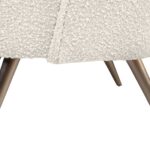 Cream bouclé accent chair with curved backrest and brushed bronze stainless steel legs, designed for modern luxury interior seating.