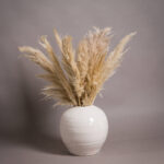 Large white handcrafted ceramic vase with rounded silhouette, crackle glazed finish, and subtly distressed stoneware texture for elegant neutral home décor.