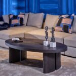 Large oval black brown oak coffee table with sculptural end legs and contemporary open tabletop detail, designed for luxury modern living spaces.
