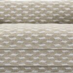 Luxury two seater sofa upholstered in LIZZO Escala patterned fabric with deep seat cushions, cylindrical accent bolsters, and elegant modern styling.